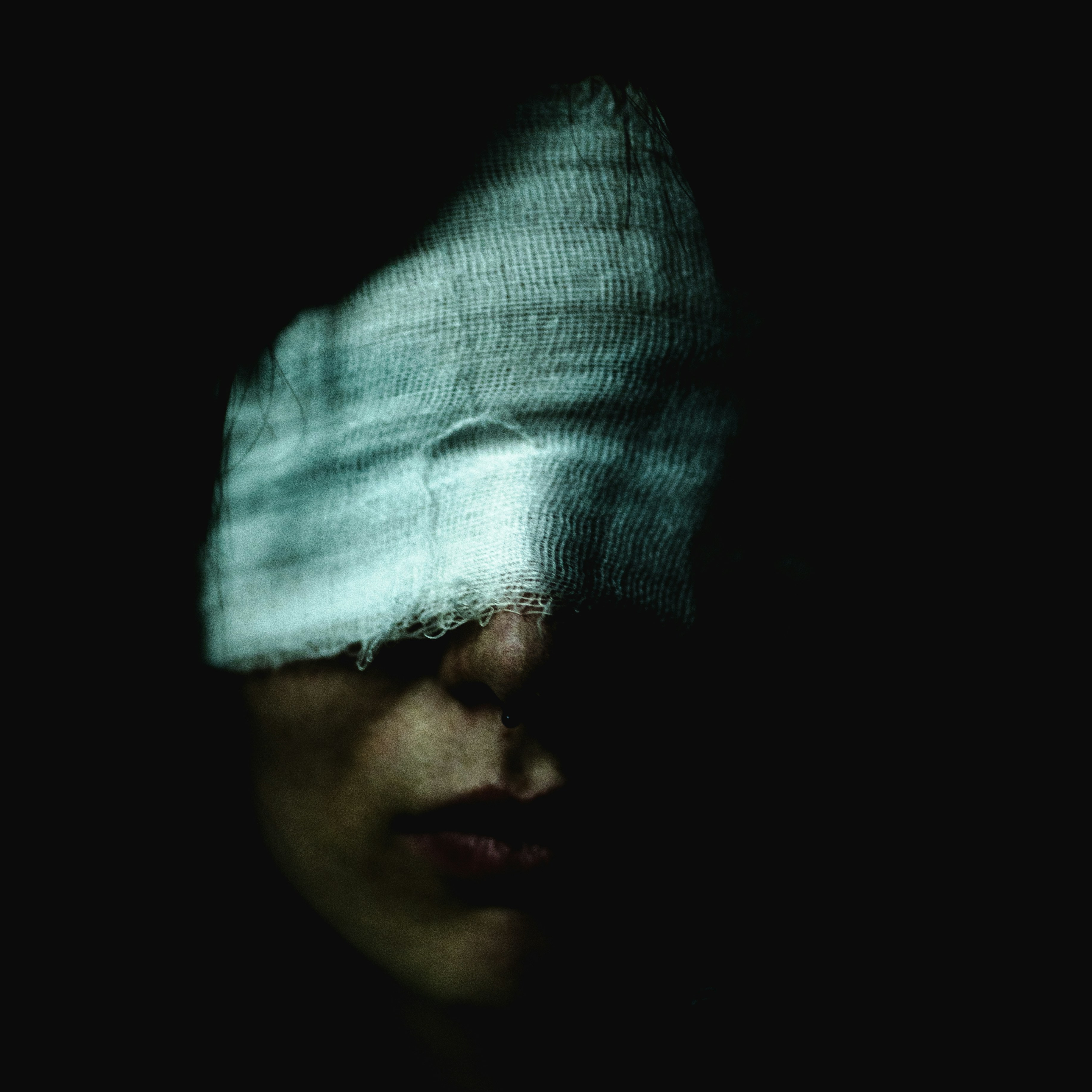 A woman with a blindfold on her face