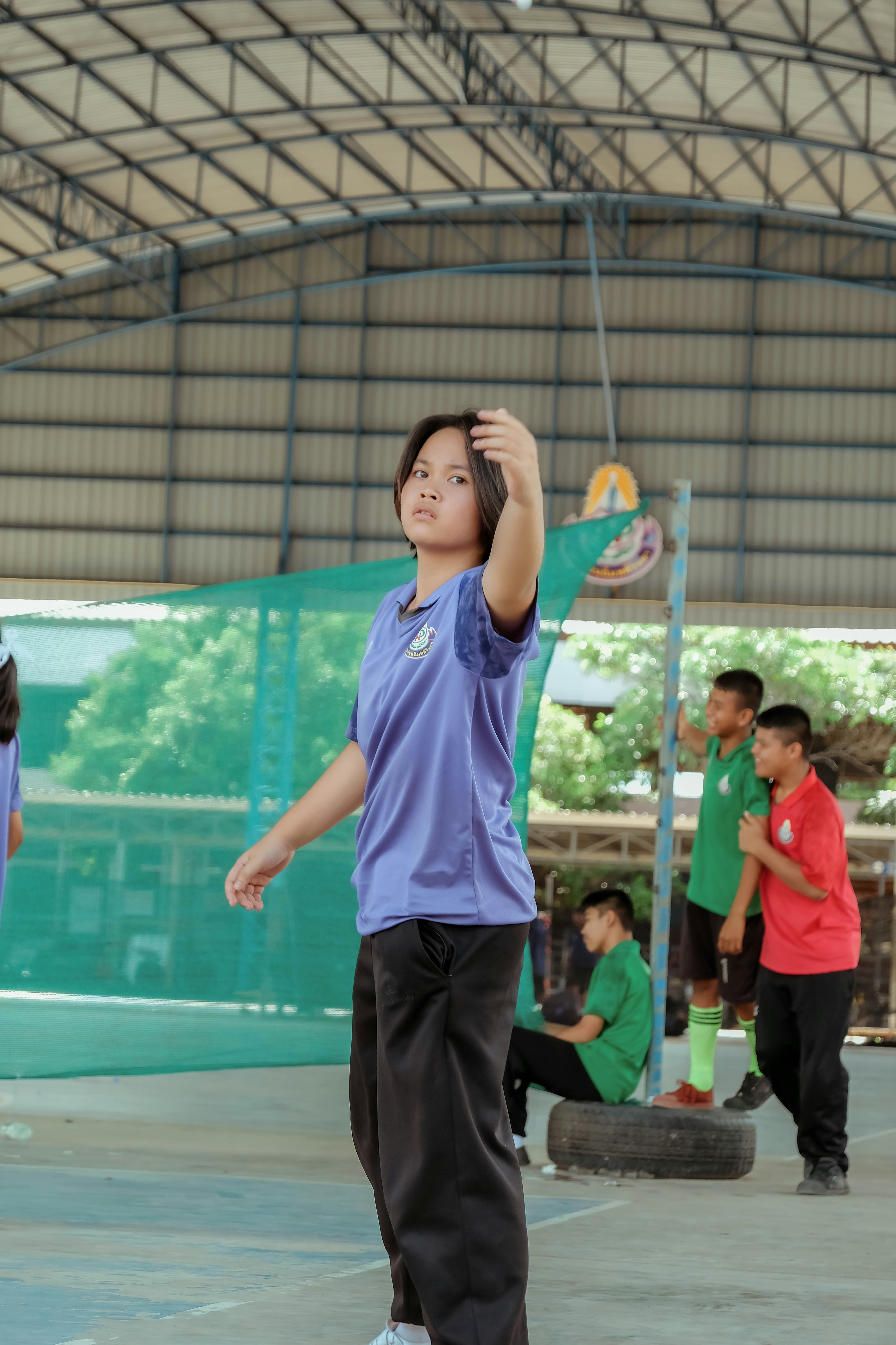 A group of young men standing on top of a basketball court