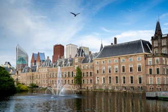 A large building with a fountain in front of it