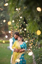 A man and a woman standing in front of a tree