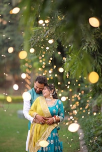 A man and a woman standing in front of a tree