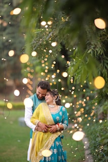 A man and a woman standing in front of a tree