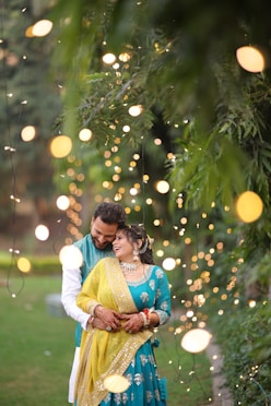 A man and a woman standing in front of a tree