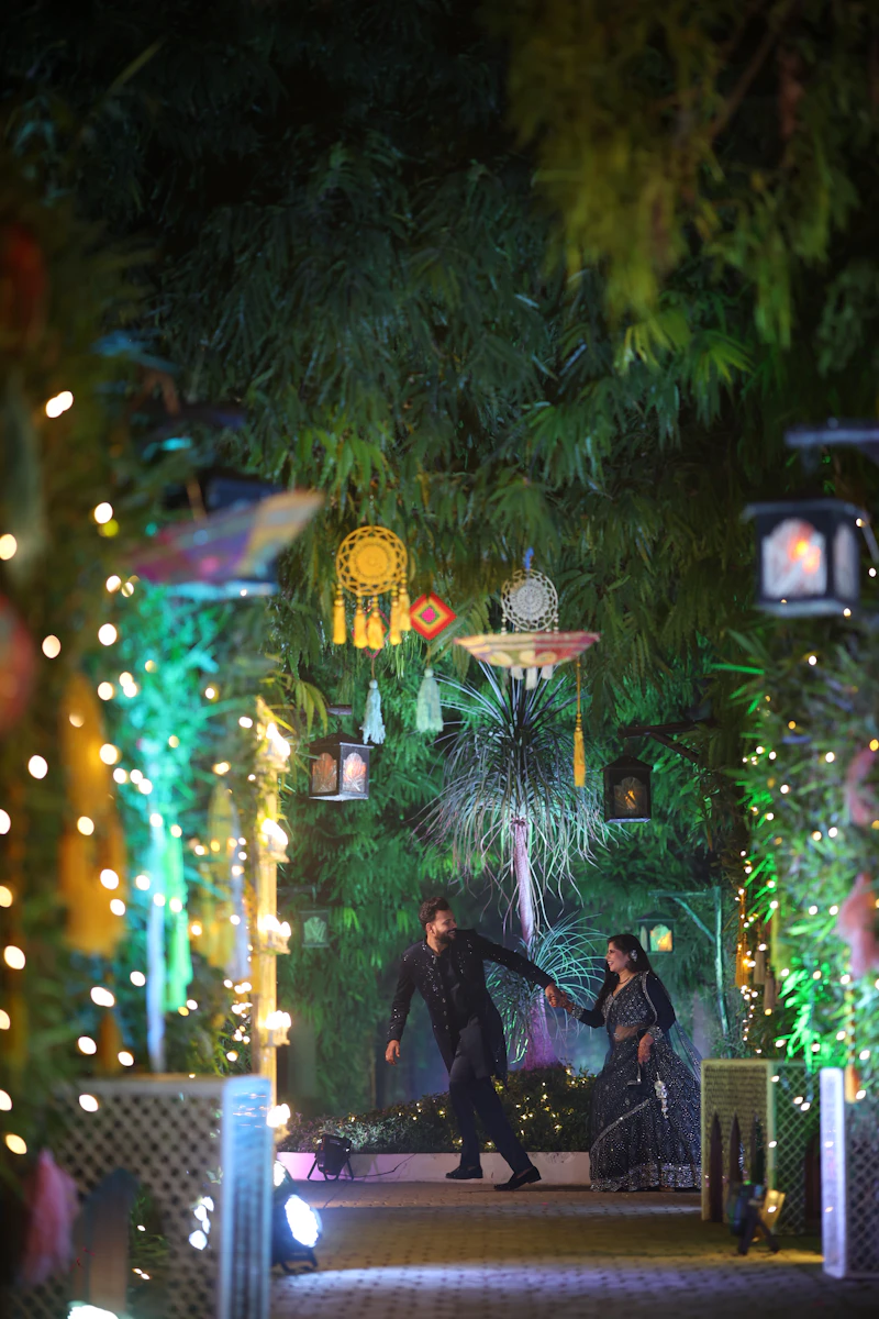 Indian couple in traditional attire at a pre-wedding photoshoot in a garden
