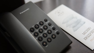A black calculator sitting on top of a table