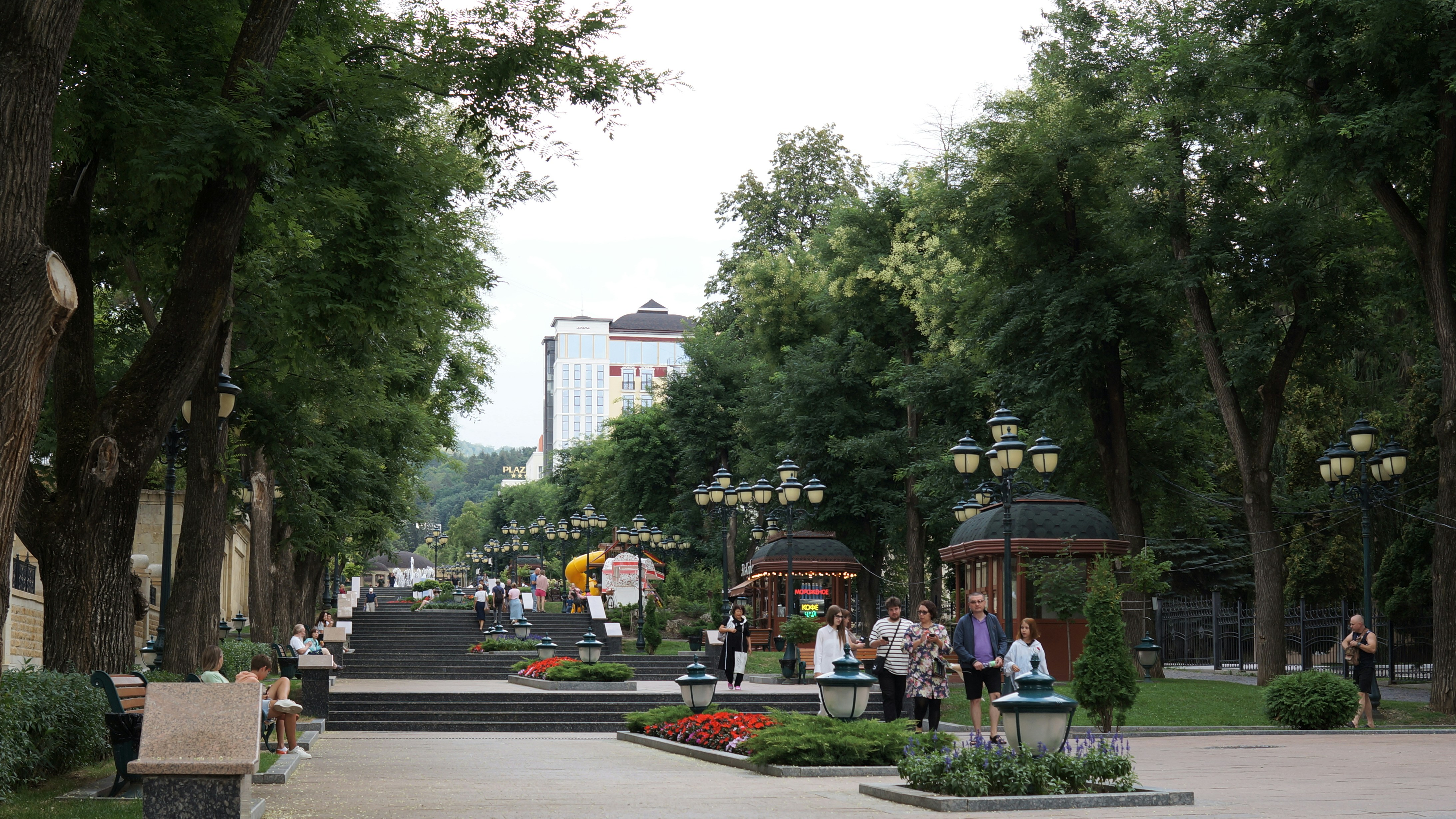 A group of people sitting on benches in a park