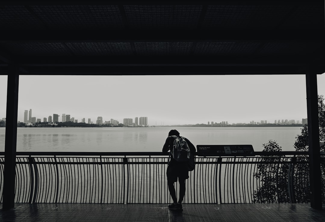 A person standing in front of a body of water,