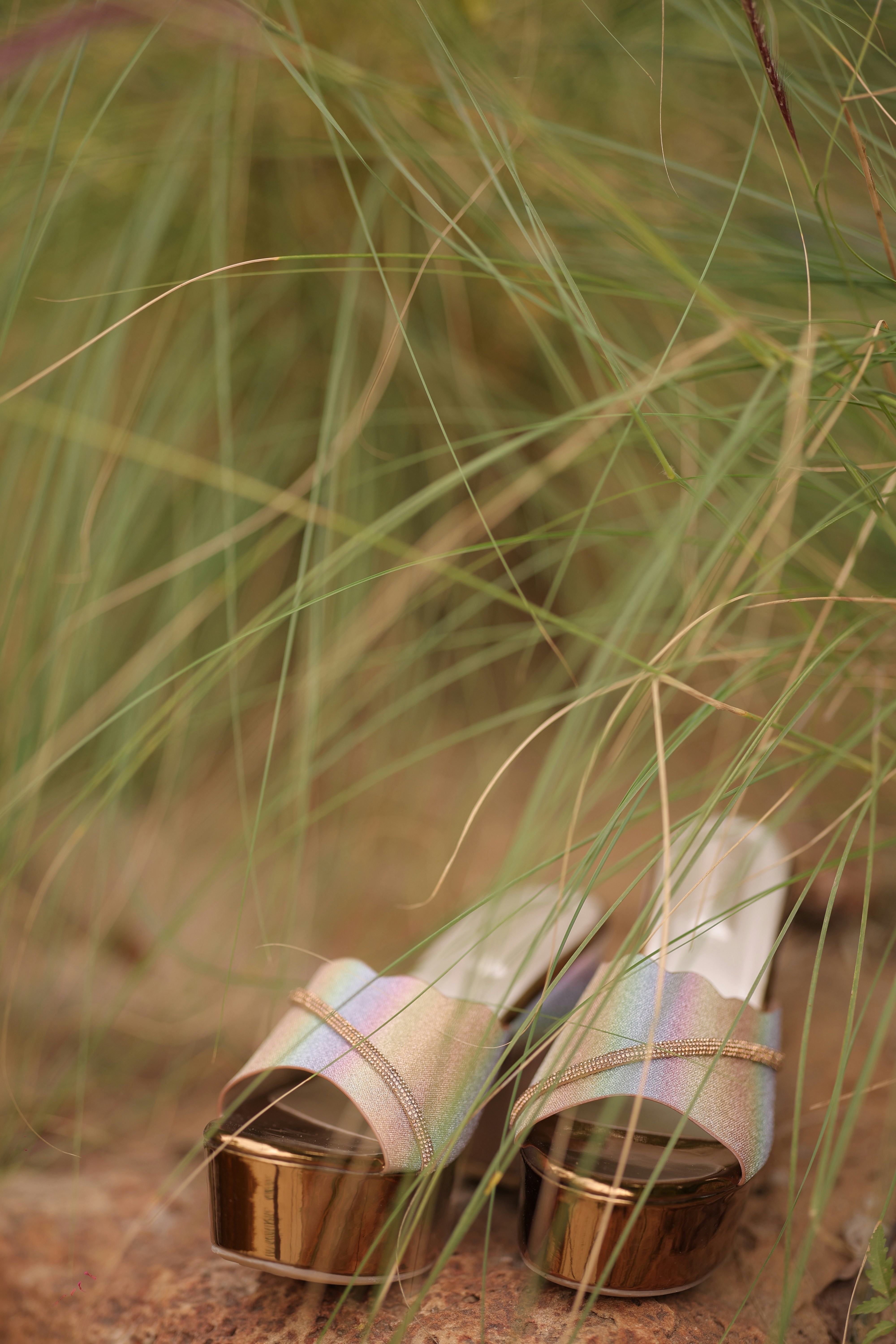 A pair of shoes sitting on top of a sandy beach