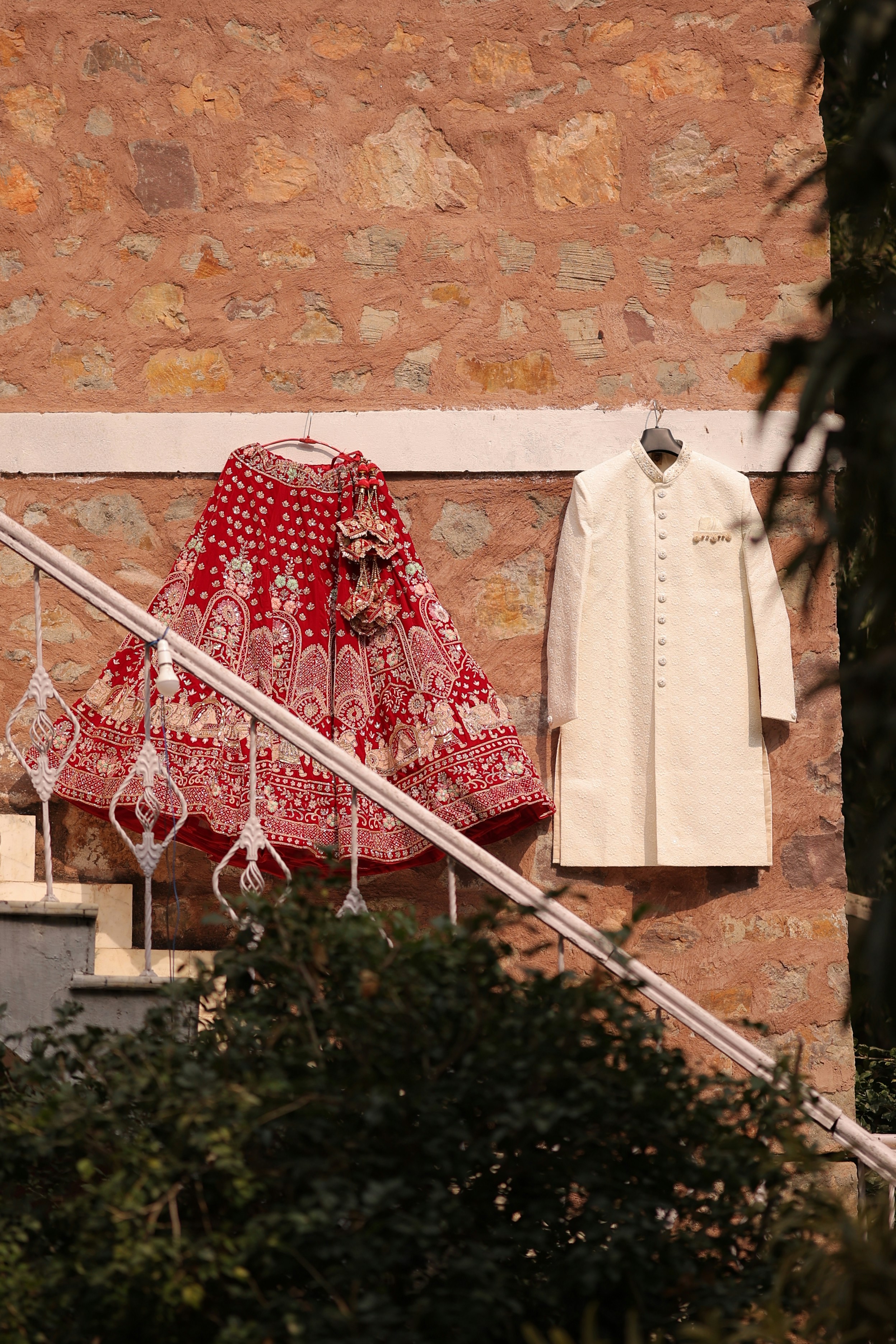 A detailed view of the groom's sherwani, showcasing its elegant design with gold threadwork and intricate patterns, perfect for a traditional Indian wedding.