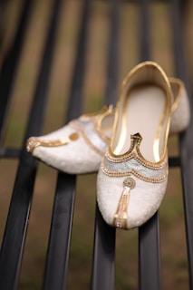 A pair of white shoes sitting on top of a metal bench