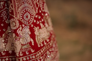 A close up of a red and gold dress