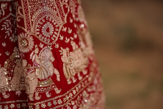 A close up of a red and gold dress