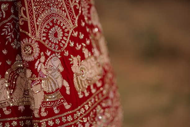 A close up of a red and gold dress