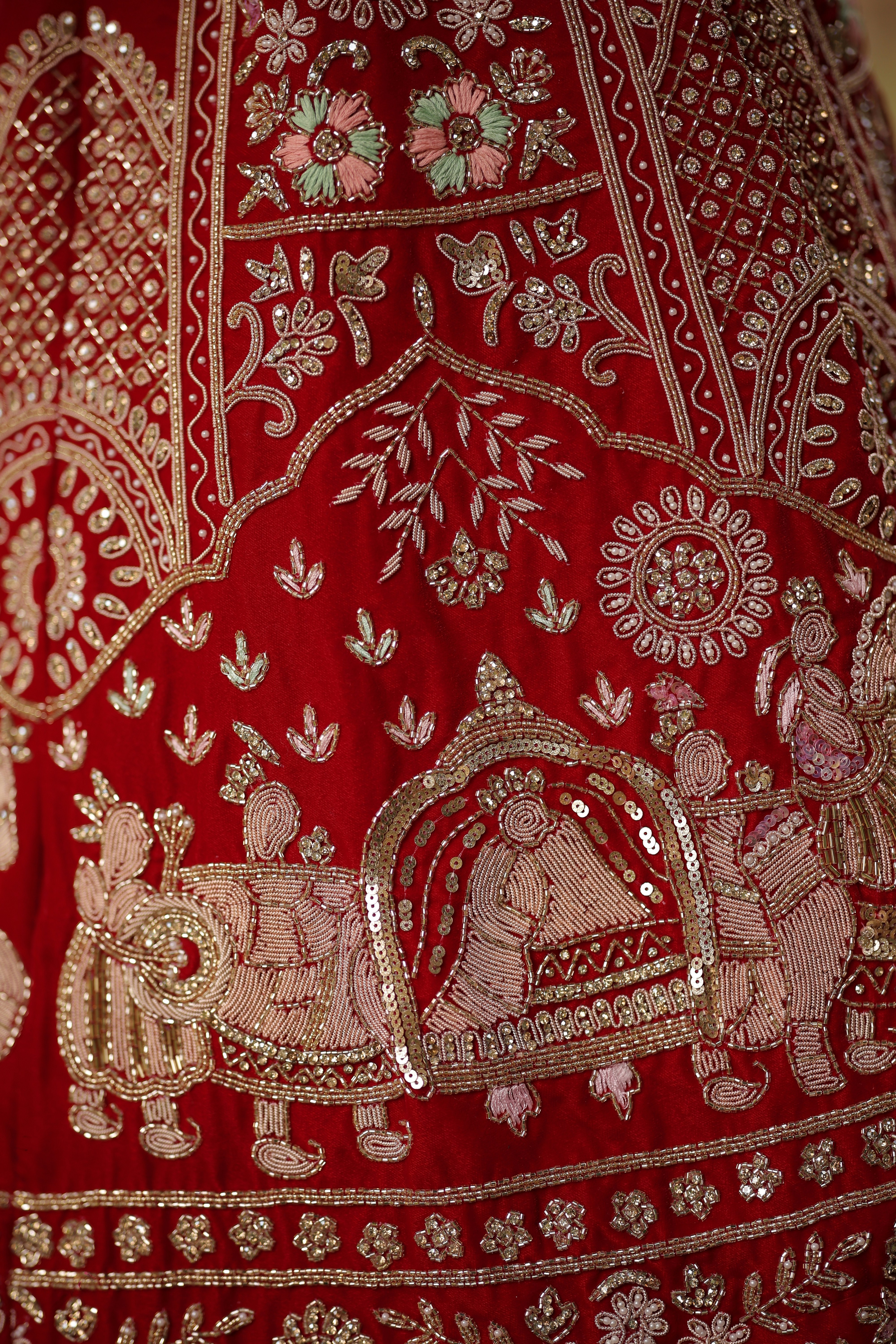 A close up of a red and gold dress