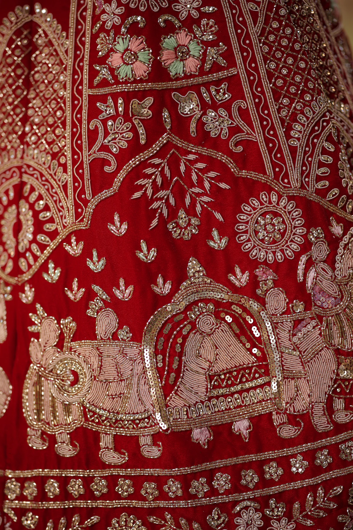 Red and gold Kutchi zardozi embroidery close-up