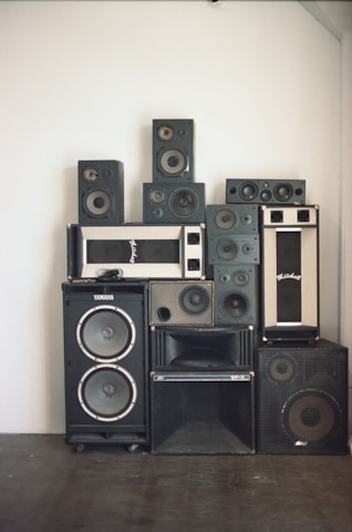 A bunch of speakers are stacked on top of each other