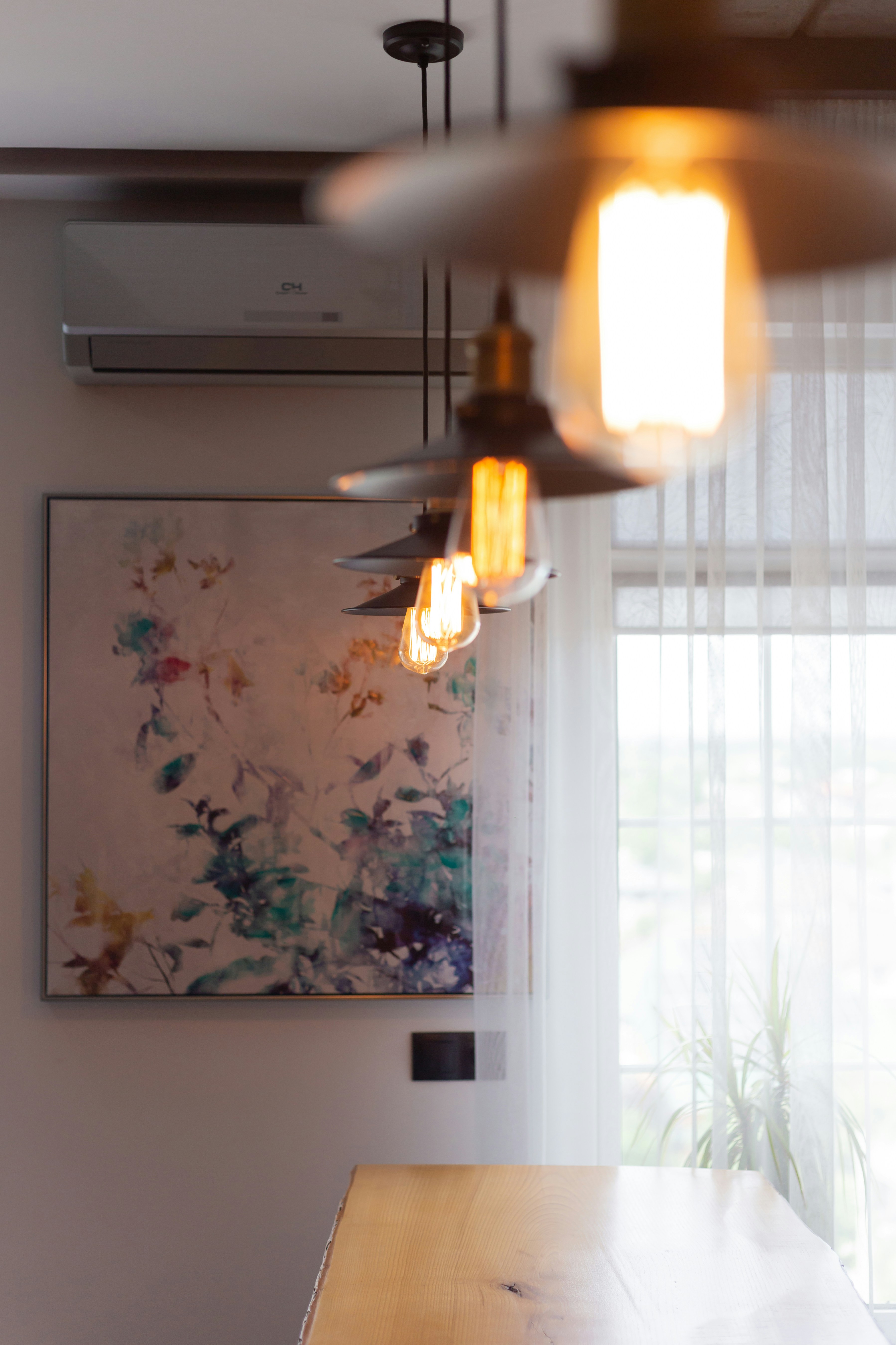 A wooden table sitting under a ceiling fan