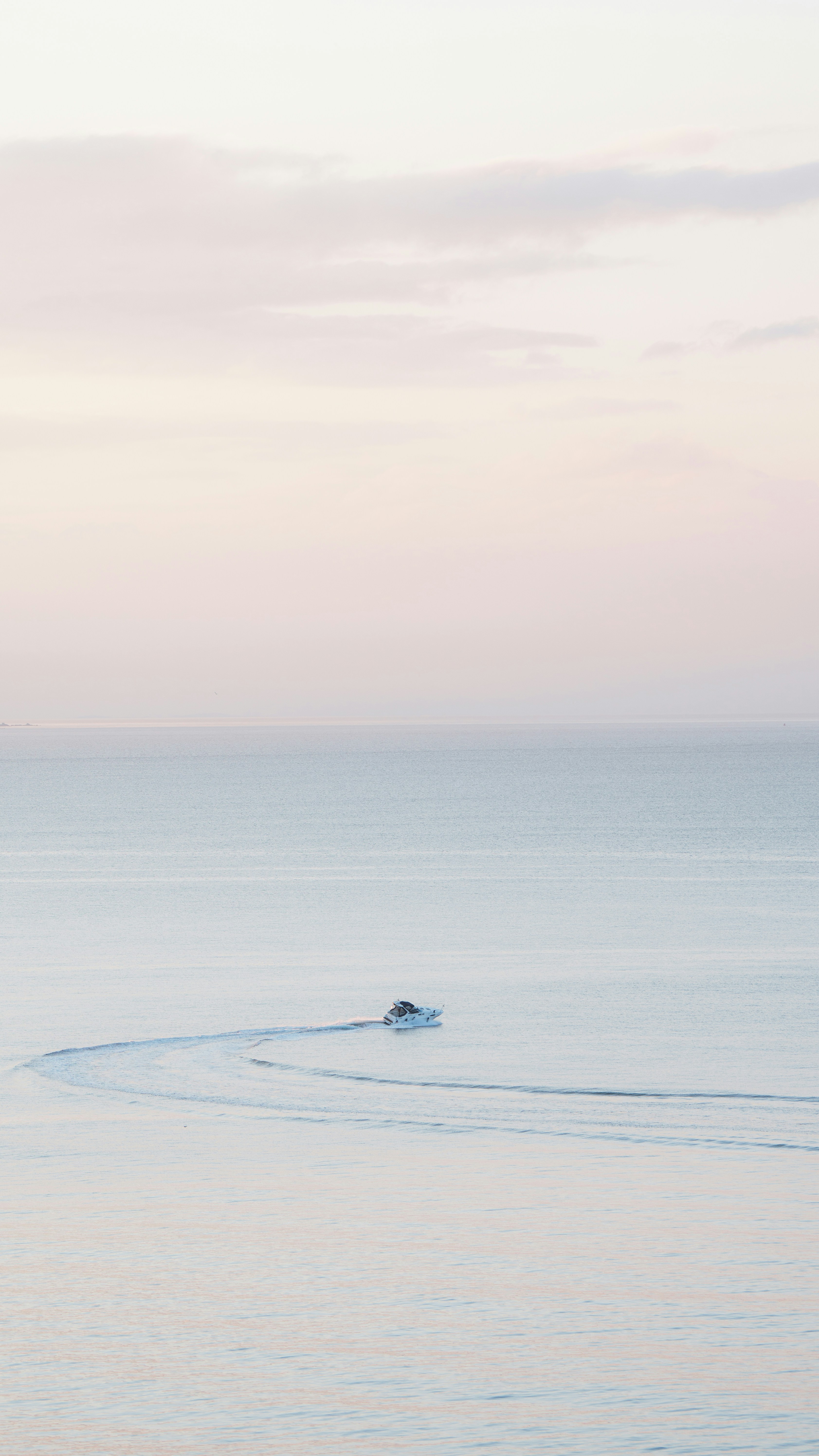A small boat in the middle of a large body of water