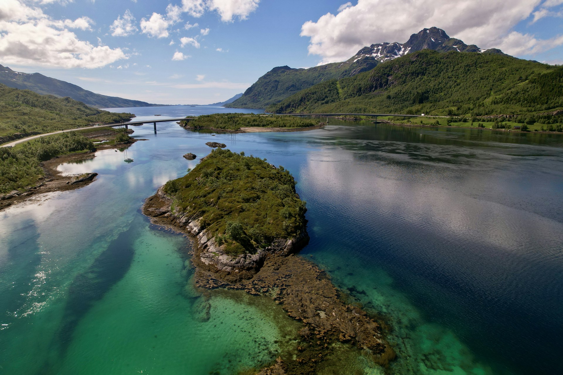 An aerial view of a body of water surrounded by mountains