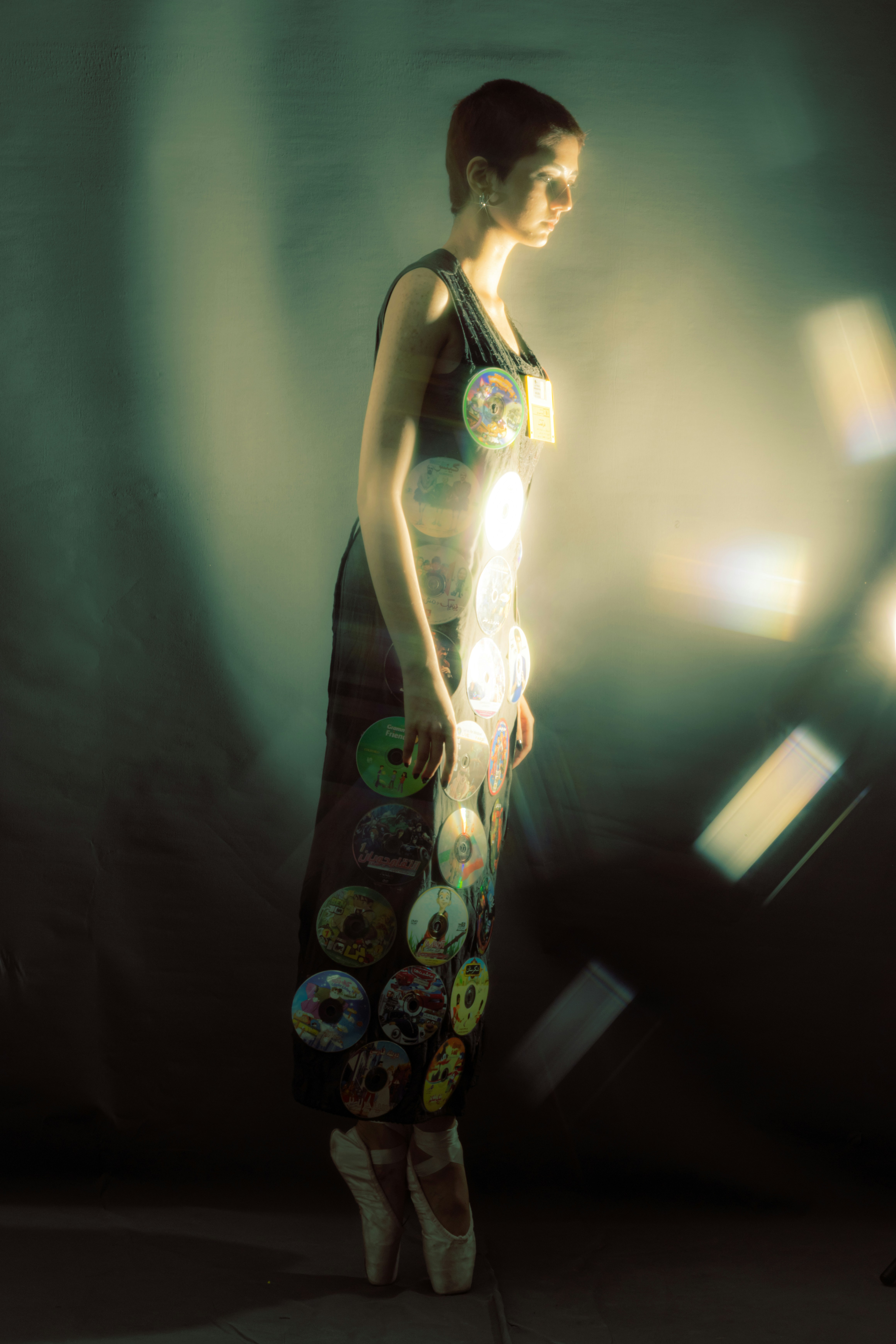 A woman standing in front of a wall with a skateboard