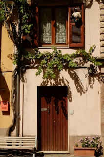 A wooden bench sitting in front of a building