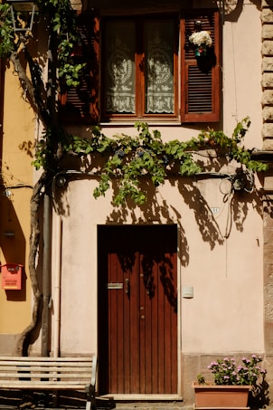 A wooden bench sitting in front of a building