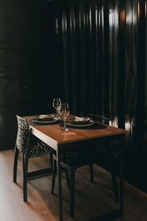 A dining table with two place settings on it