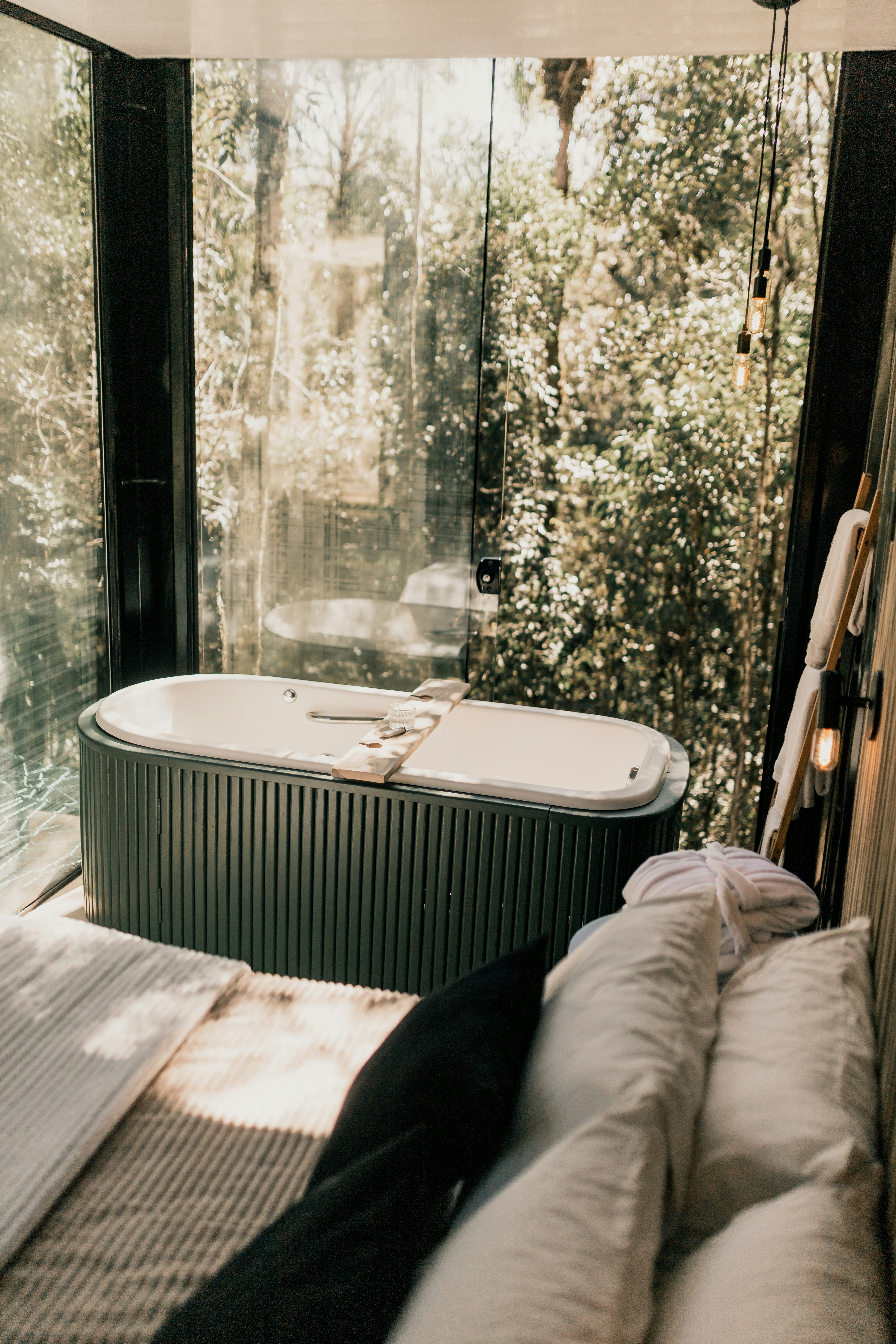 A bathroom with a large tub next to a window