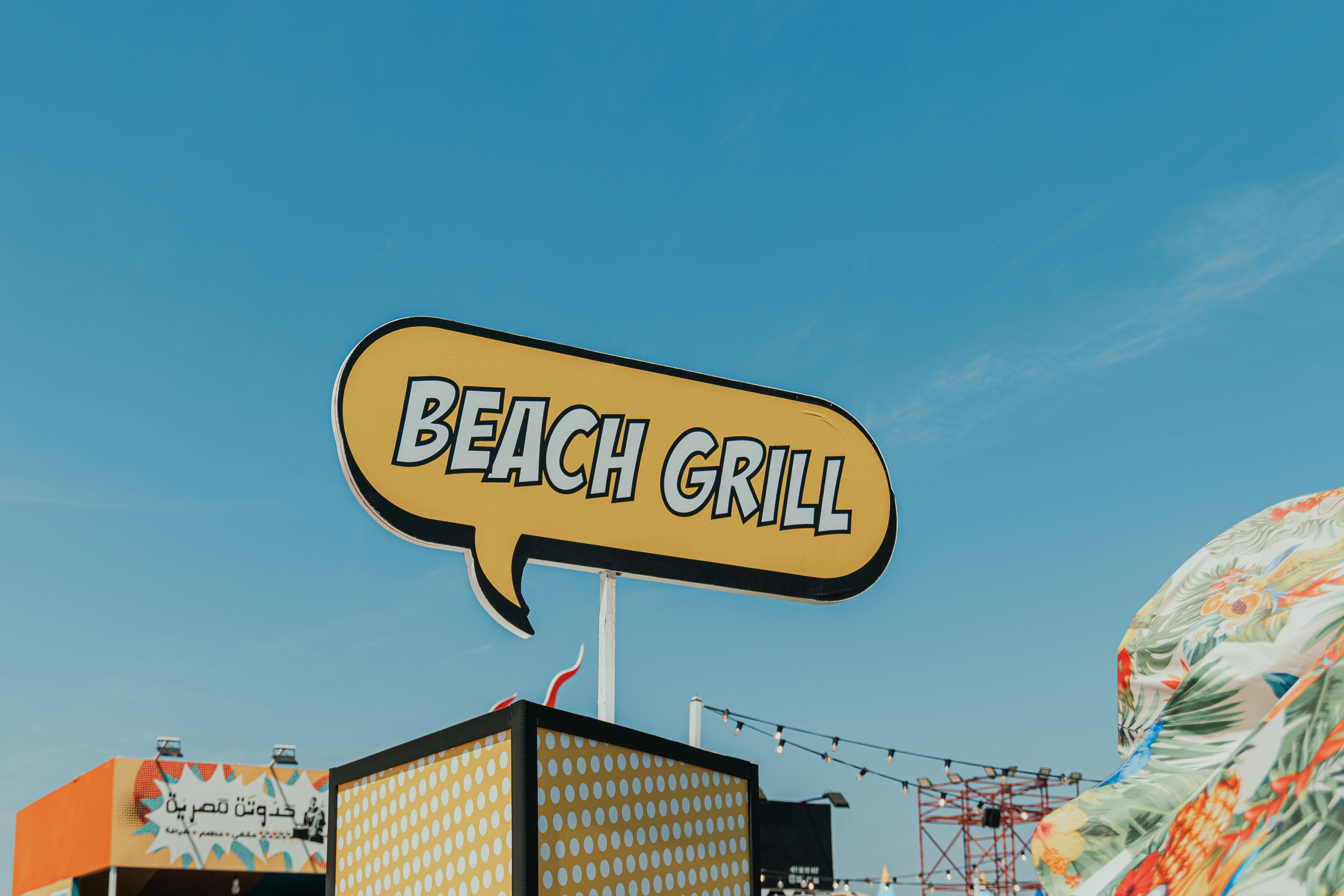 A sign that says beach grill on top of a building