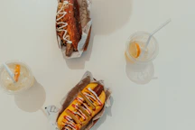 Two hotdogs and two drinks on a table
