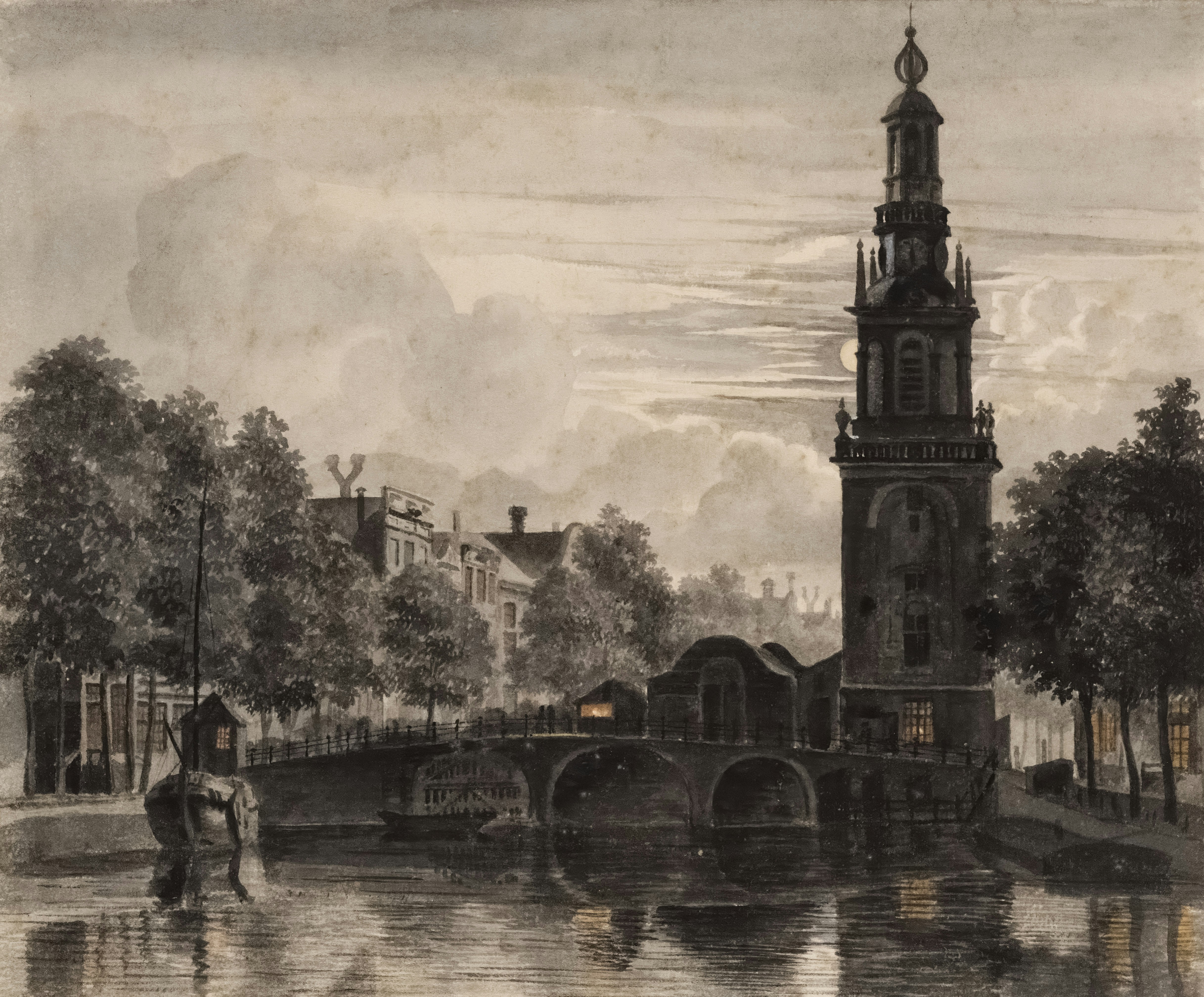 Historic tower and bridge over water at night.