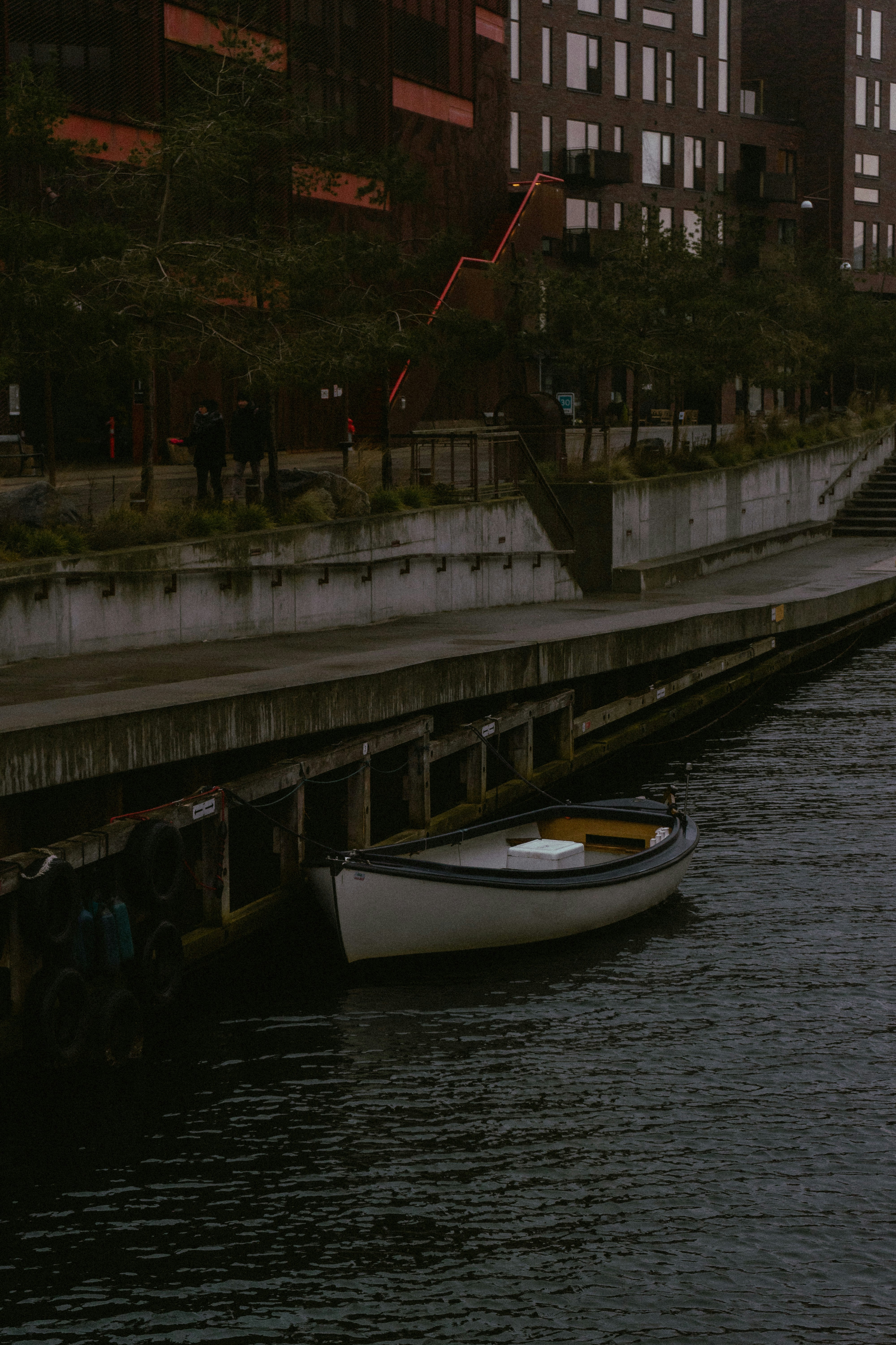 A small boat floating on top of a body of water