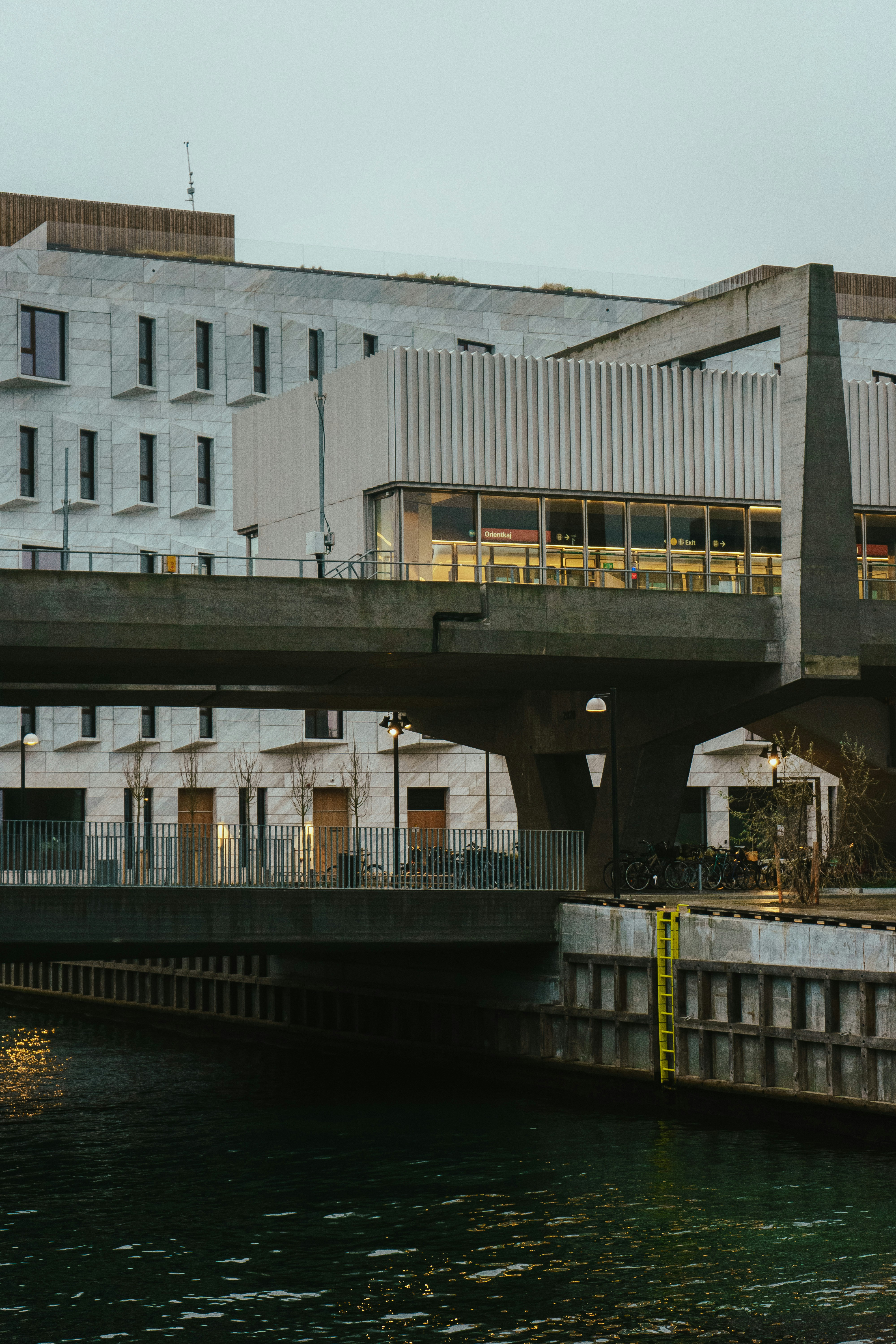 A bridge over a body of water with buildings in the background