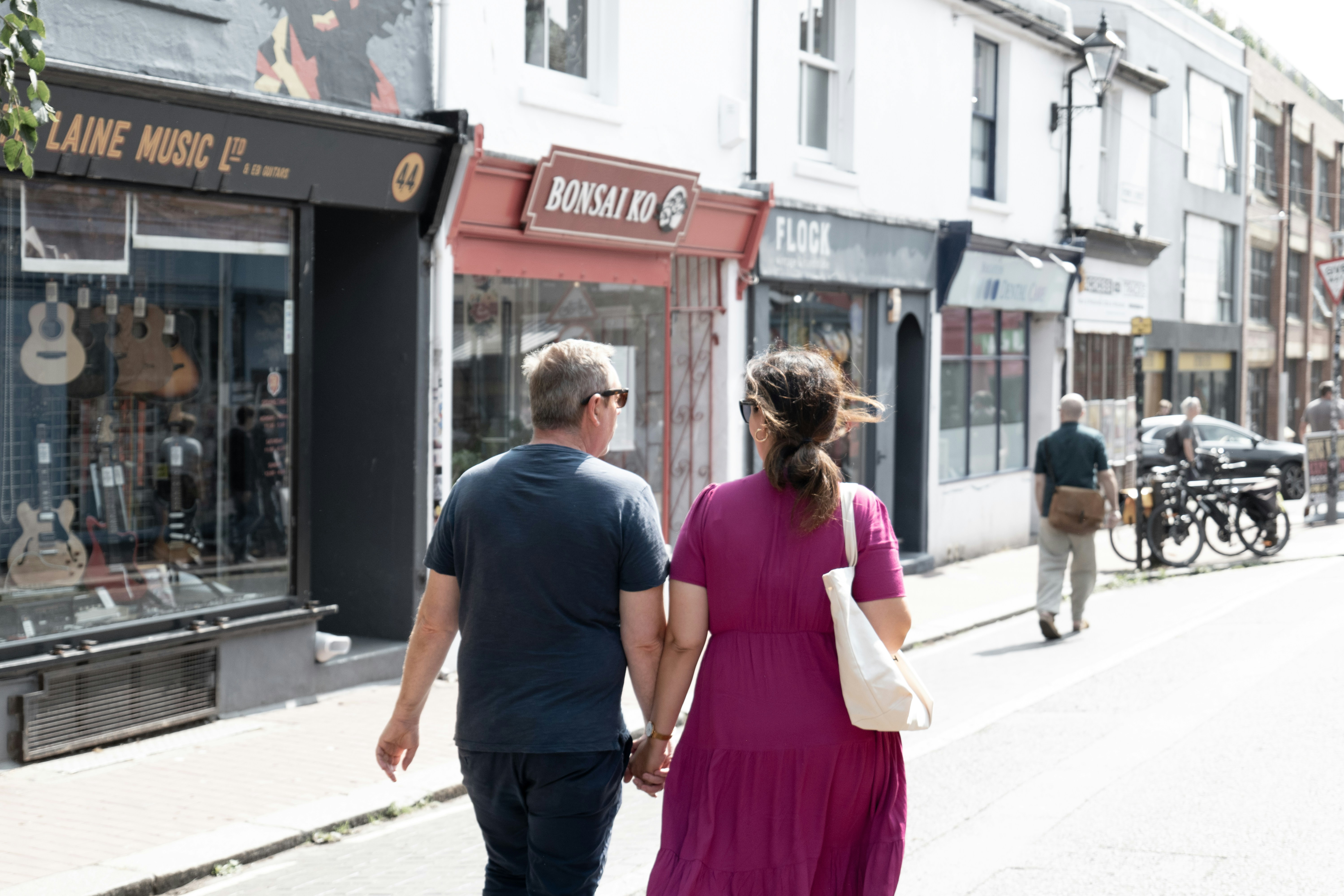 A man and a woman walking down a street