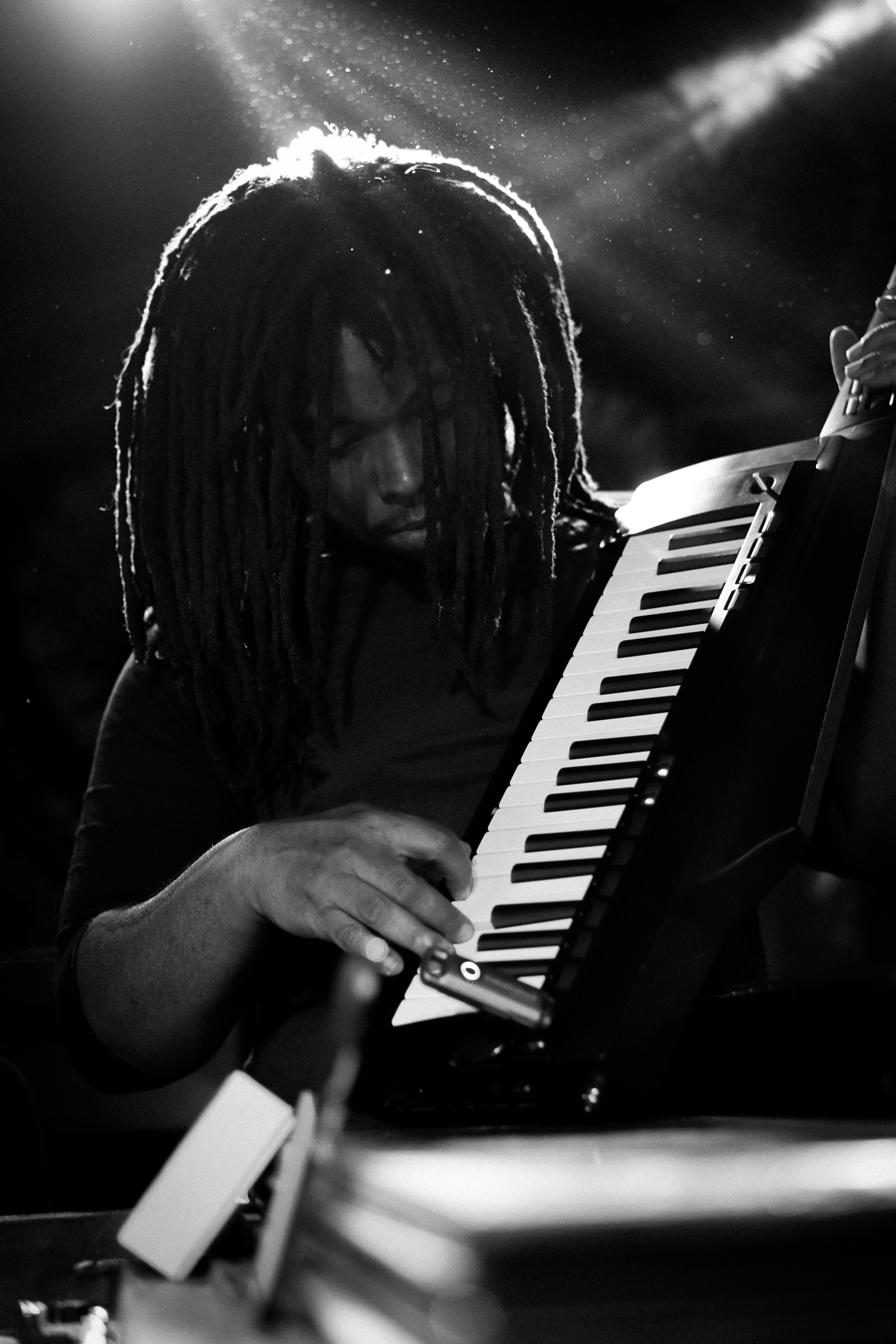 A man with dreadlocks playing an instrument