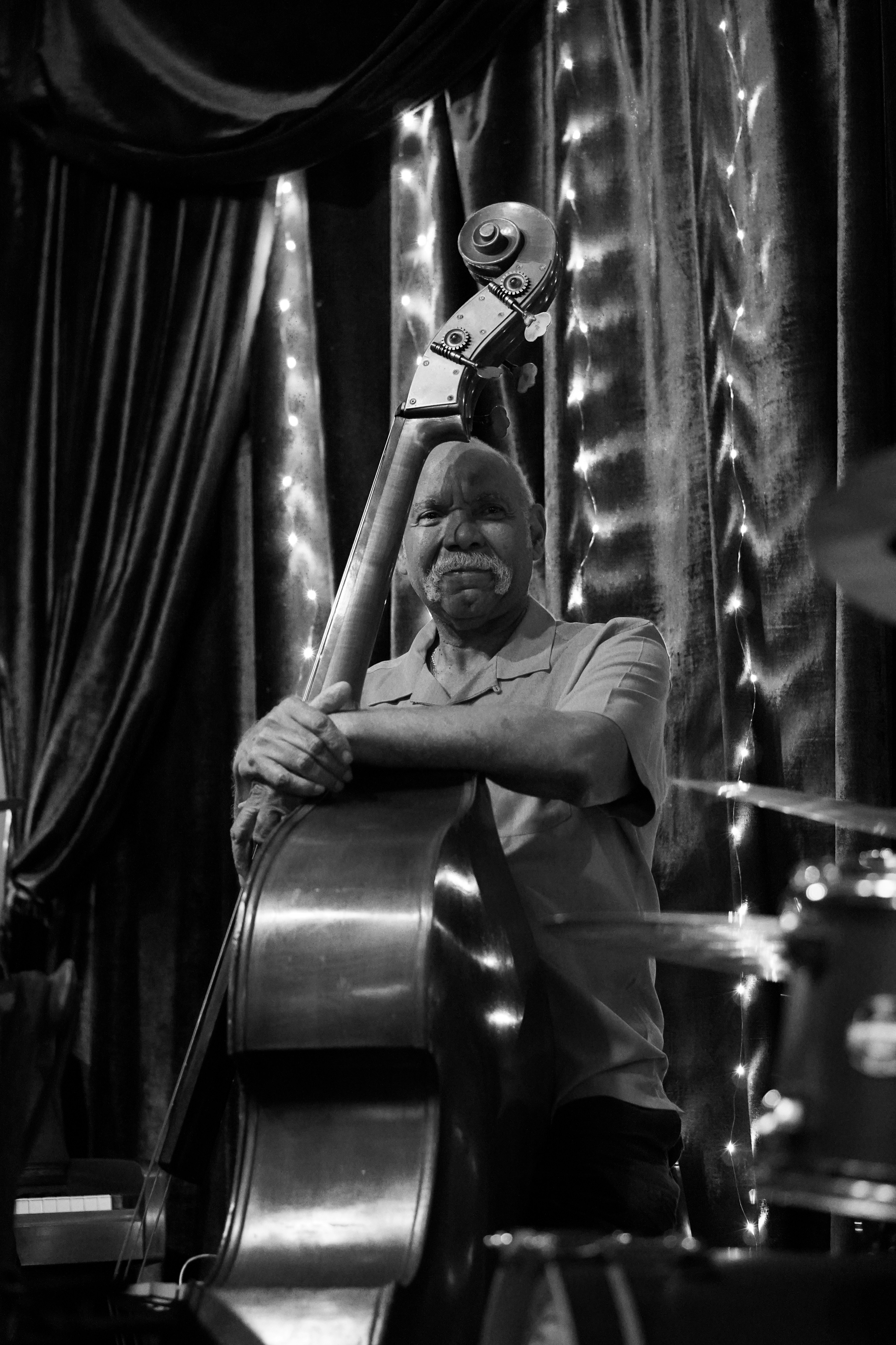 A man sitting in a chair with a musical instrument on his head