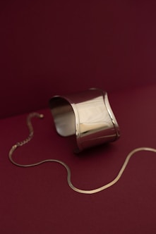 A silver object is on a red surface