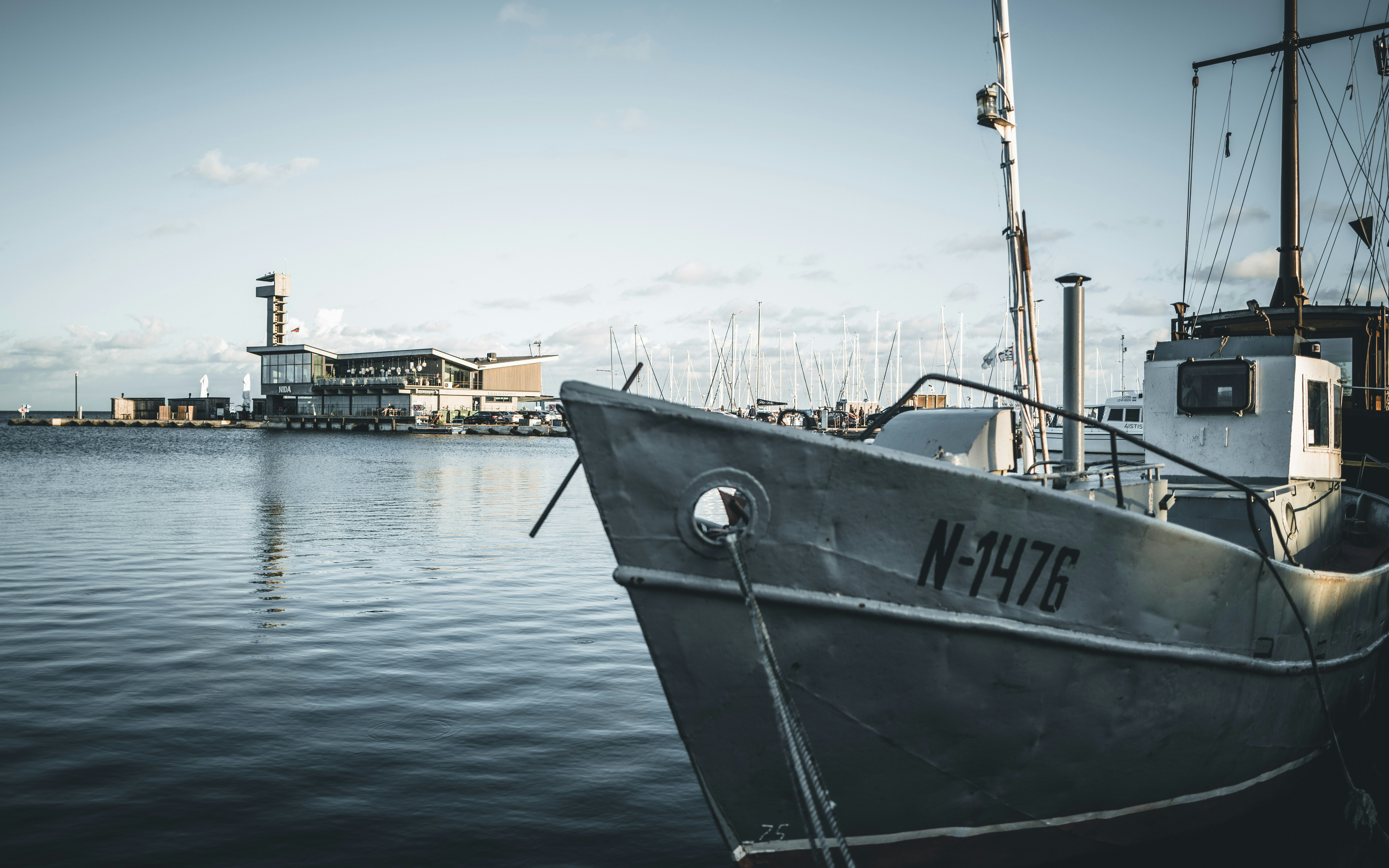 A boat that is sitting in the water, Port of Nida on the Curonian Spit, Lithuania