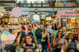 A crowd of people walking through a market