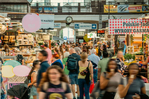 A crowd of people walking through a market