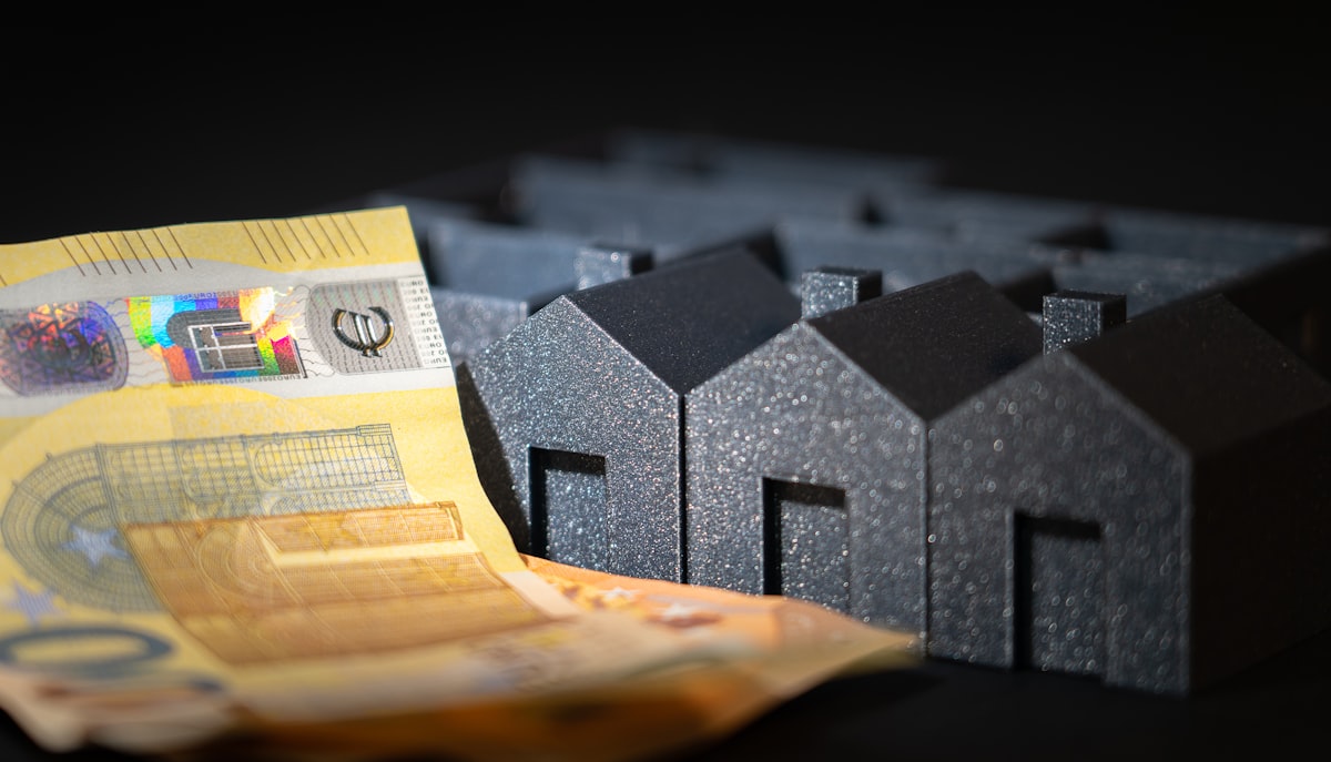 Miniature houses on a table representing housing and insurance