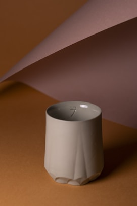 A white vase sitting on top of a table