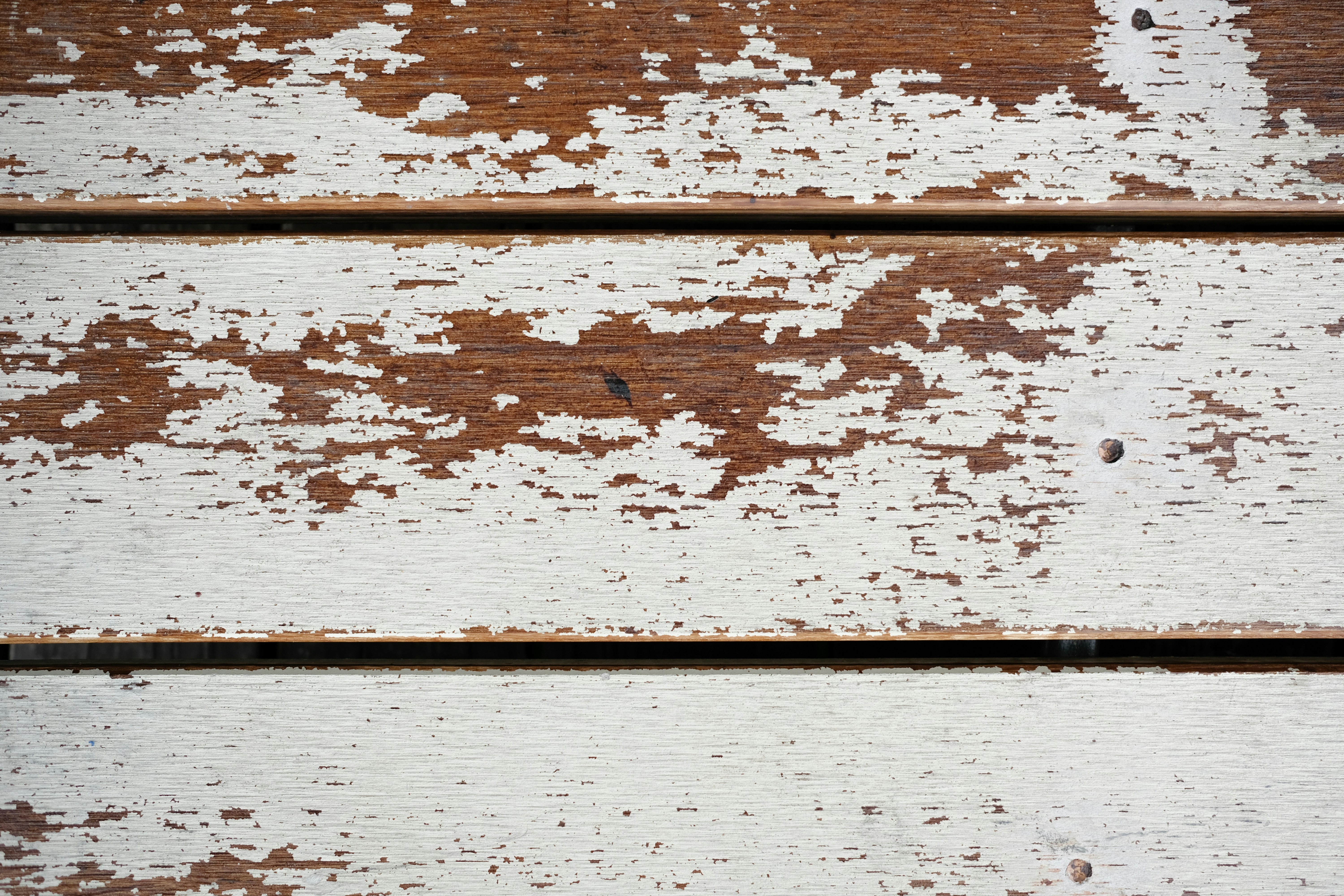 A close up of a piece of wood with white paint