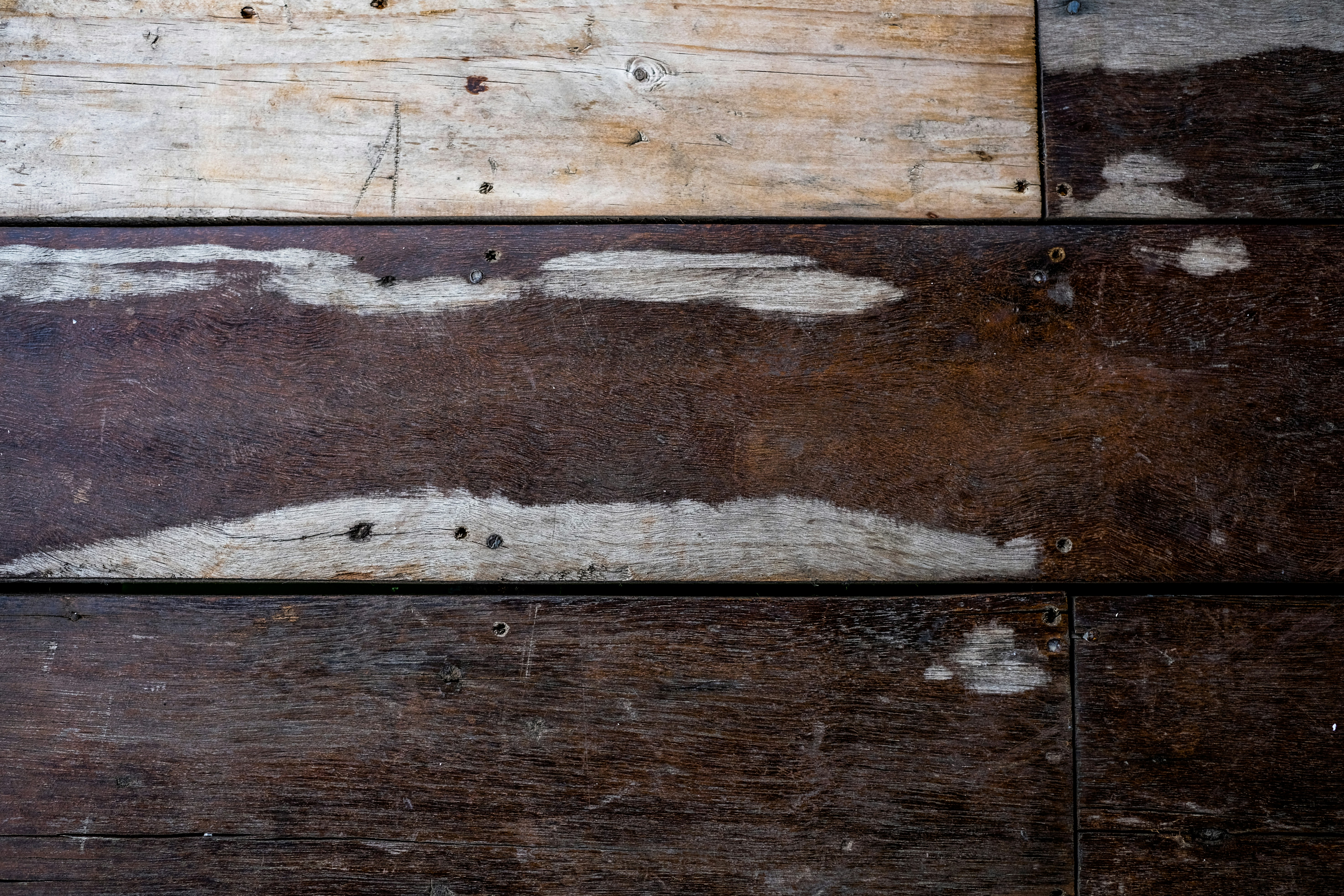 A close up of a piece of wood with peeling paint