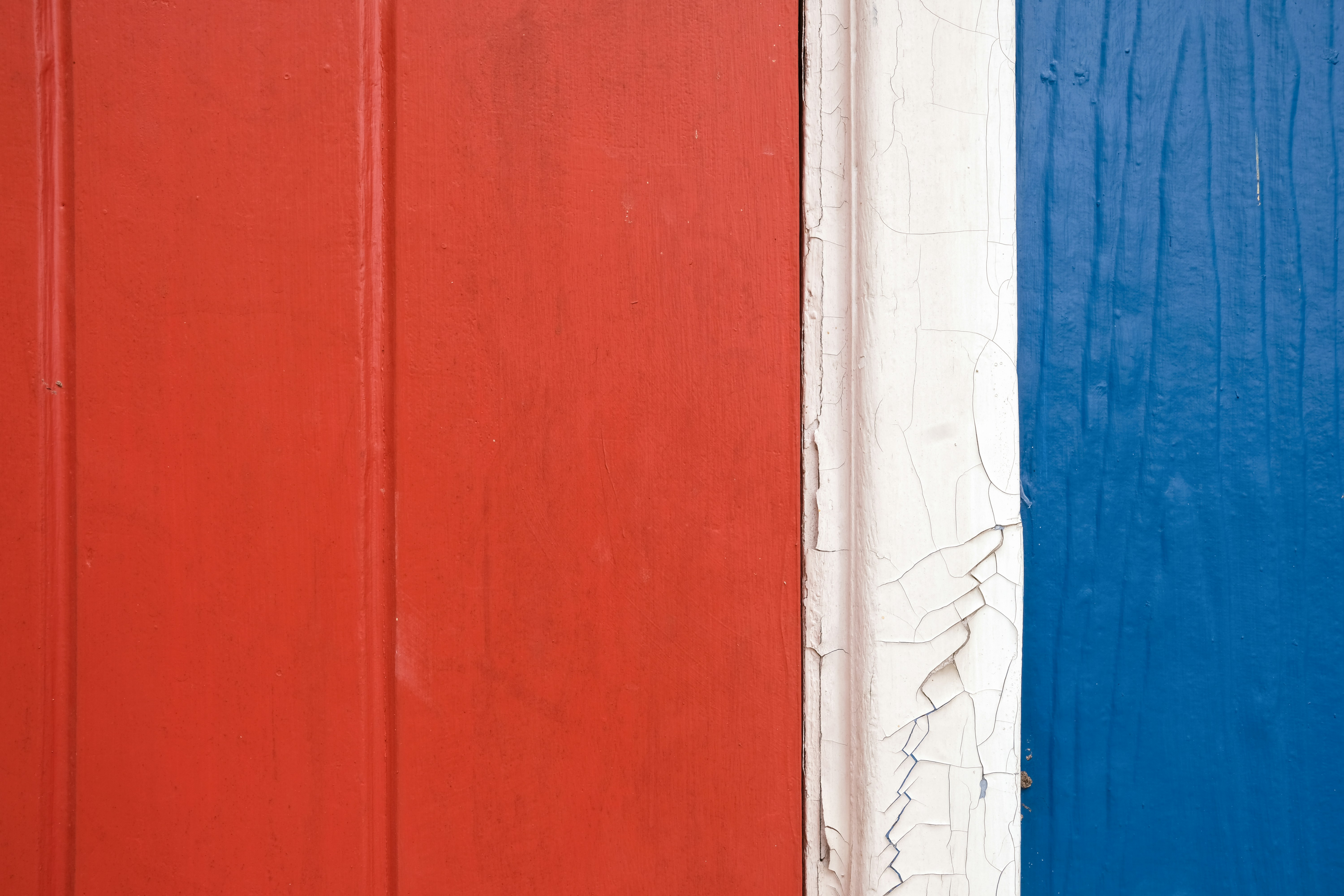 A red, white, and blue door with a clock on it