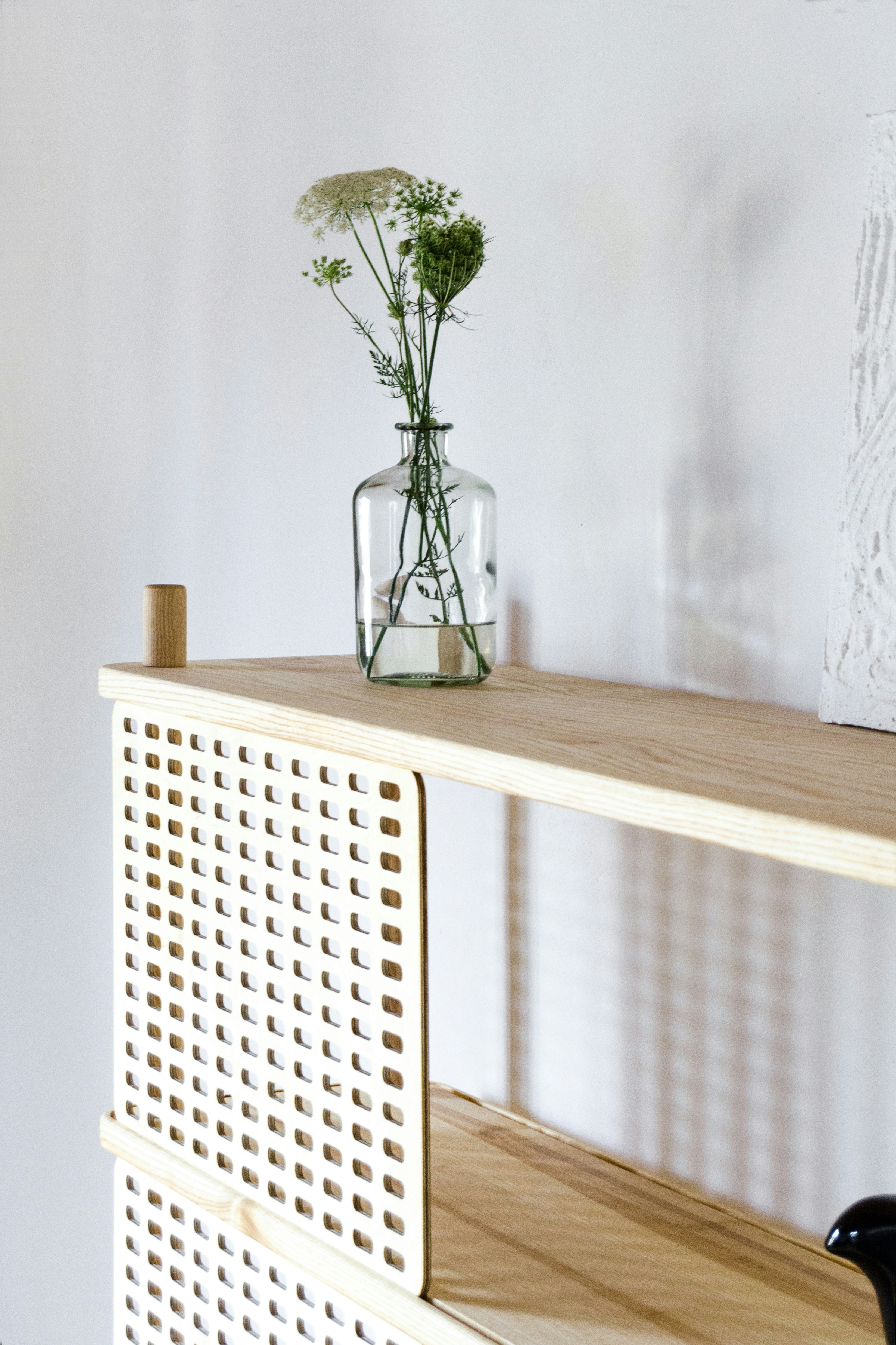 Built-in wood shelf with ceramic vase composition