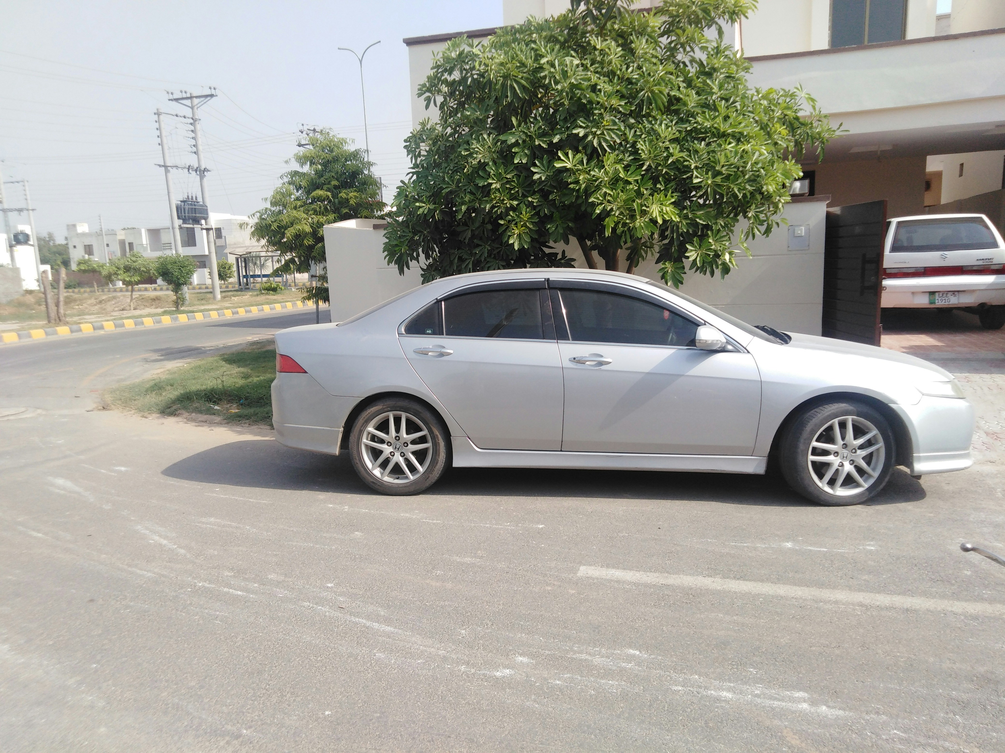 Silver sedan car parked on highway