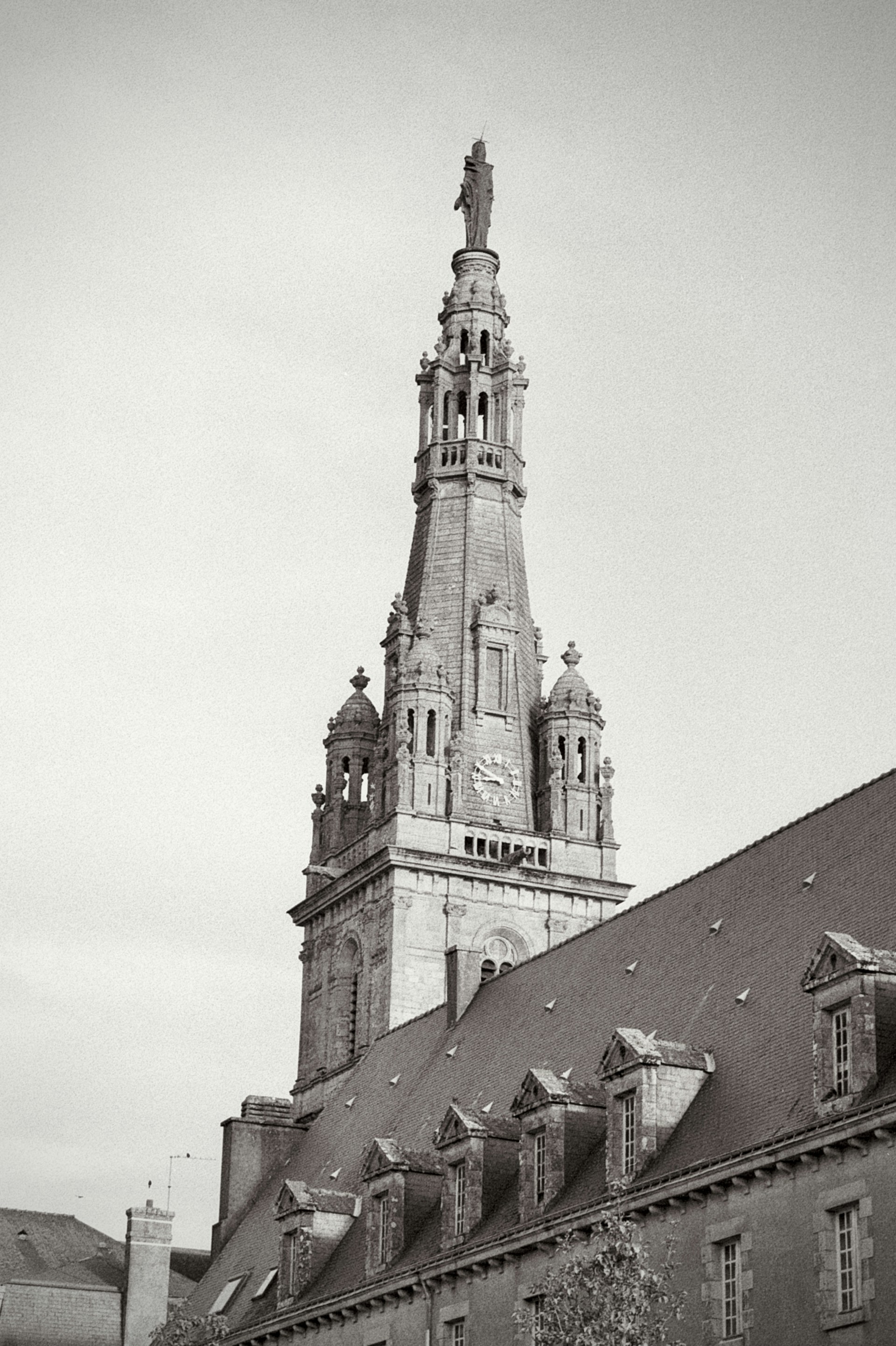 A black and white photo of a building with a clock tower