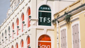 A tall white building with a red door