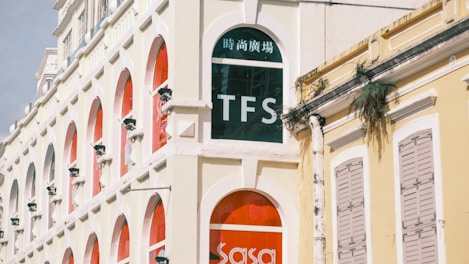 A tall white building with a red door